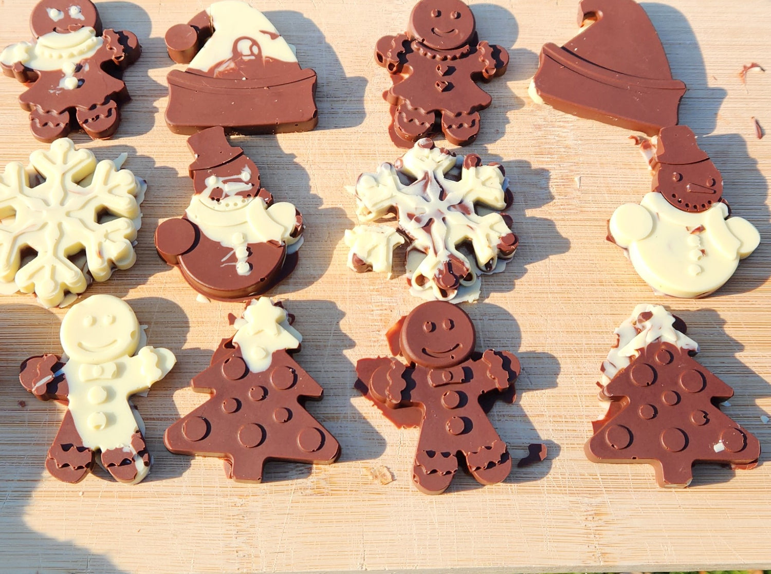 Homemade chocolates shaped as gingerbread people, snowflakes, snowmen Christmas trees & Santa hats, made with the CocoaBlox DIY chocolate kit